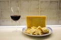 Plate with parmigiana regiano cheese and red wine