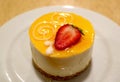 Plate of Passion Fruit Cheese Cake Topped with Fresh Strawberry Royalty Free Stock Photo