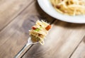 Plate of Pasta Carbonara and Spaghetti with bacon and parmesan cheese on a fork on old wooden table Royalty Free Stock Photo