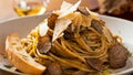A plate of pasta with mushrooms and bread on a table, AI Royalty Free Stock Photo