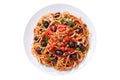 Plate of pasta puttanesca with olives, tomato sauce, anchovies and capers isolated on white background