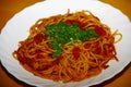 Plate with pasta, tomatosauce, basil and other herbs seafood