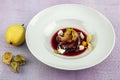 Plate of pears poached in red wine, dessert decorated with on wooden table