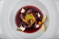 Plate of pears poached in red wine, dessert decorated with on wooden table