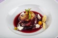 Plate of pears poached in red wine, dessert decorated with on wooden table