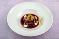 Plate of pears poached in red wine, dessert decorated with on wooden table