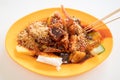 A plate of Penang rojak which is a delicacy typically consists of cucumber, pineapple, deep-fried tofu, mango and cuttlefish