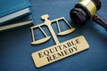 Plate with phrase Equitable remedy and a gavel. Royalty Free Stock Photo