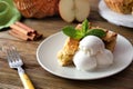 Plate with piece of delicious apple pie and ice cream on wooden table Royalty Free Stock Photo