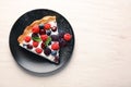 Plate with piece of delicious berry pie on white wooden table Royalty Free Stock Photo