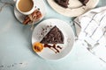 Plate with piece of delicious chocolate cake and cup of coffee on light table Royalty Free Stock Photo