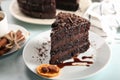 Plate with piece of delicious chocolate cake on light table Royalty Free Stock Photo