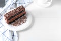 Plate with piece of delicious chocolate cake on light table Royalty Free Stock Photo