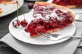 Plate with piece of tasty homemade cherry pie on wooden table, closeup Royalty Free Stock Photo