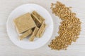 Plate with pieces of halva, heap of peeled sunflower seeds Royalty Free Stock Photo