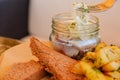Plate of pieces of herring with fried potato,onion. Close up with selective focus Royalty Free Stock Photo