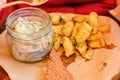 Plate of pieces of herring with fried potato,onion. Close up with selective focus Royalty Free Stock Photo
