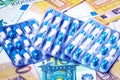 Plate with pills on the background of euro bills. The concept of the expensive cost of healthcare Royalty Free Stock Photo