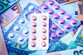 Plate with pills on the background of euro bills. The concept of the expensive cost of healthcare Royalty Free Stock Photo