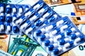 Plate with pills on the background of euro bills. The concept of the expensive cost of healthcare Royalty Free Stock Photo