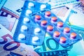 Plate with pills on the background of euro bills. The concept of the expensive cost of healthcare