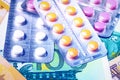 Plate with pills on the background of euro bills. The concept of the expensive cost of healthcare Royalty Free Stock Photo