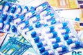 Plate with pills on the background of euro bills. The concept of the expensive cost of healthcare