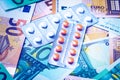 Plate with pills on the background of euro bills. Royalty Free Stock Photo