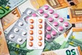 Plate with pills on the background of euro bills Royalty Free Stock Photo