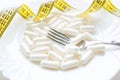 Plate with pills and measuring tape close-up concept diet Royalty Free Stock Photo