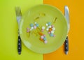 Plate of pills vitamins healthy pharmaceutical concept medicament a colored background Royalty Free Stock Photo