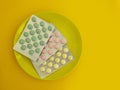 Plate of pills vitamins  a colored background Royalty Free Stock Photo