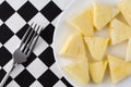 Plate of pineapple slices with a fork on a tablecloth Royalty Free Stock Photo