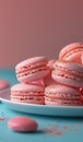 Plate of Pink Macaroons on Blue Table Royalty Free Stock Photo