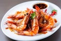 plate of piping hot tiger shrimp prawns with tangy spicy sauce