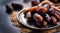 Plate of pitted dates on a dark wooden background. Top view