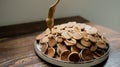 Dutch mini pancakes with honey and peanut butter on the wooden background.