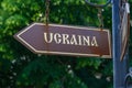 Plate or pointer with an arrow, inscription Ukraine in Romanian. Background with copy space Royalty Free Stock Photo