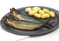 Plate with Potatoes and Smoked Herring or Bouffi Bloater, clupea harengus Royalty Free Stock Photo