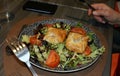 Plate with puff pastries on a bed of salad.