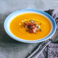 A plate of pumpkin soup with a jamon, garlic, thyme and cream Royalty Free Stock Photo