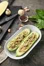 Plate with quinoa stuffed zucchini boats and spices on grunge table Royalty Free Stock Photo