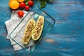 Plate with quinoa stuffed zucchini boats and vegetables on wooden table Royalty Free Stock Photo