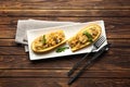 Plate with quinoa stuffed zucchini boats on wooden table Royalty Free Stock Photo
