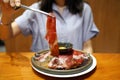 A plate of raw sliced premium wagyu beef with marbled texture, served with organic yolk egg in soy sauce, Prepared for Japanese