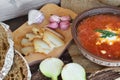 A plate of red borscht and bread with lard