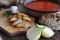 A plate of red borscht with lard and onions on burlap