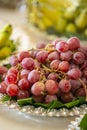 Plate of red grapes in a cluster on a table being catered for a wedding ceremony Royalty Free Stock Photo