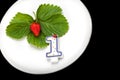 A plate with red strawberry and candle Royalty Free Stock Photo