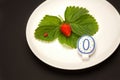 A plate with red strawberry and candle Royalty Free Stock Photo